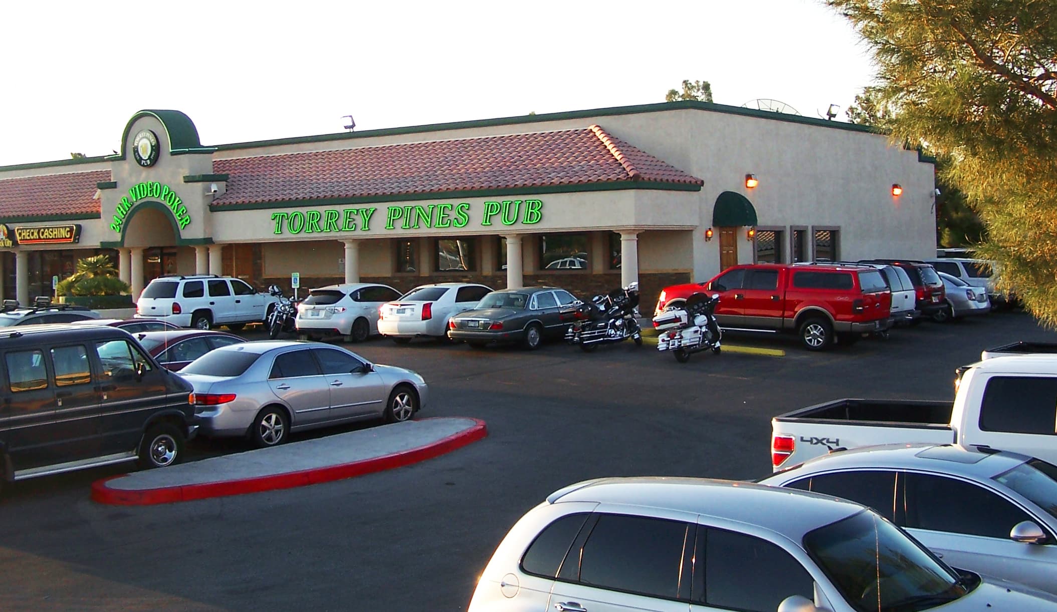 Torrey Pines Pub exterior with green neon sign